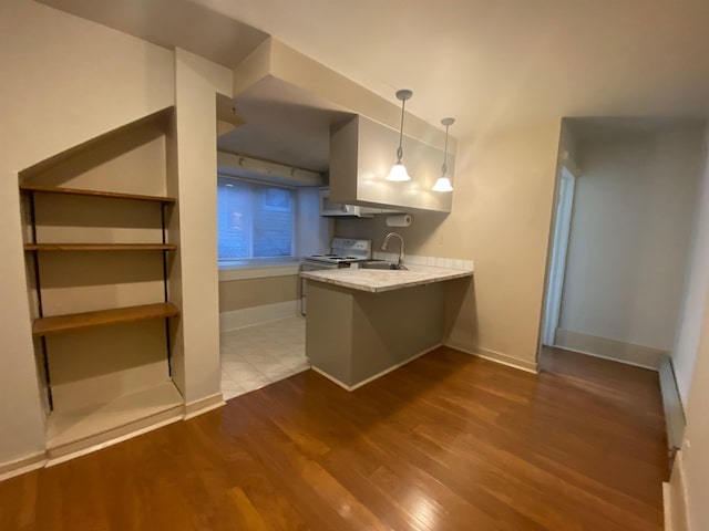 1621 W 9th Ave, Spokane, WA 99223 - kitchen featuring light countertops, dark wood-type flooring, a peninsula, a sink, and hanging light fixtures