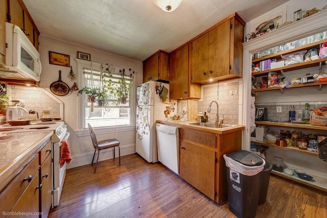 1621 W 9th Ave, Spokane, WA 99223 - kitchen featuring white appliances, brown cabinets, light wood-style flooring, tasteful backsplash, and a textured ceiling