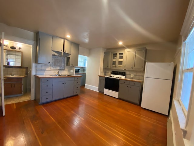 1621 W 9th Ave, Spokane, WA 99223 - kitchen featuring freestanding refrigerator, range with electric cooktop, gray cabinetry, stainless steel microwave, and decorative backsplash