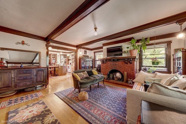 1621 W 9th Ave, Spokane, WA 99223 - living area with crown molding, light wood-type flooring, a fireplace, plenty of natural light, and beamed ceiling