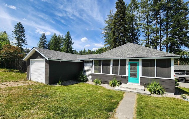 424 W Larch St, Newport, WA 99156 - view of front of home with a shingled roof, a front yard, and a sunroom