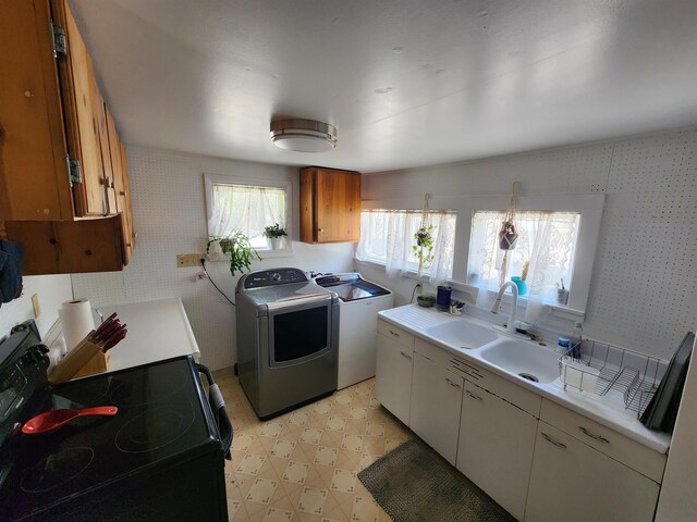 424 W Larch St, Newport, WA 99156 - kitchen with electric stove, light floors, light countertops, and independent washer and dryer
