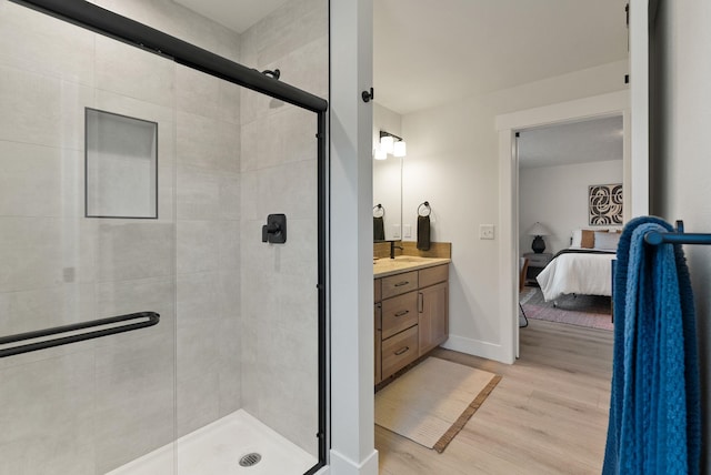 14101 E Sanson Ave, Spokane Valley, WA 99216 - full bath featuring ensuite bath, wood finished floors, a shower stall, vanity, and baseboards