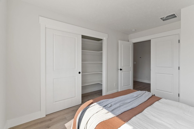 14101 E Sanson Ave, Spokane Valley, WA 99216 - bedroom featuring light wood finished floors, baseboards, and a closet