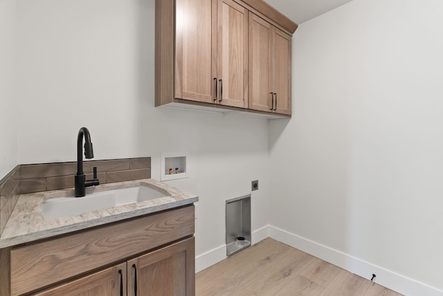 14101 E Sanson Ave, Spokane Valley, WA 99216 - washroom with cabinet space, hookup for a washing machine, light wood-type flooring, hookup for an electric dryer, and baseboards