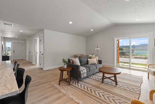 14101 E Sanson Ave, Spokane Valley, WA 99216 - living area with light wood finished floors, baseboards, healthy amount of natural light, a textured ceiling, and lofted ceiling
