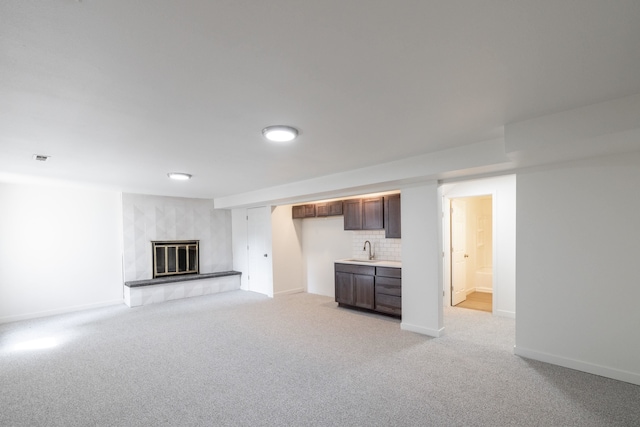 624 N Herald Rd Unit 2, Spokane Valley, WA 99206 - unfurnished living room featuring light colored carpet, a fireplace, baseboards, and bar with sink