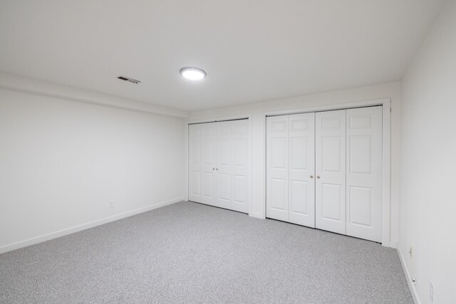 624 N Herald Rd Unit 2, Spokane Valley, WA 99206 - unfurnished bedroom with multiple closets, carpet flooring, and baseboards