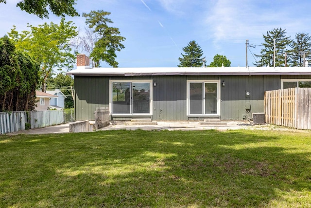 624 N Herald Rd Unit 2, Spokane Valley, WA 99206 - back of property with entry steps, a chimney, and central AC