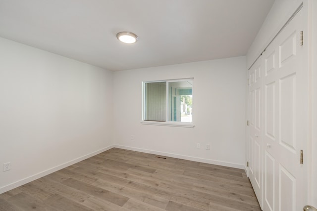 624 N Herald Rd Unit 2, Spokane Valley, WA 99206 - unfurnished bedroom with light wood-style flooring, a closet, and baseboards