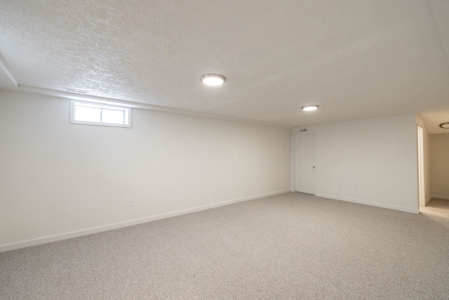 624 N Herald Rd Unit 2, Spokane Valley, WA 99206 - below grade area featuring a textured ceiling, light colored carpet, and baseboards