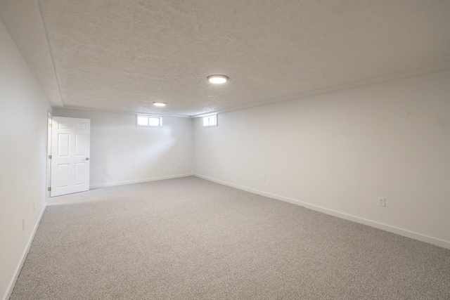 624 N Herald Rd Unit 2, Spokane Valley, WA 99206 - below grade area featuring light carpet, baseboards, and a textured ceiling