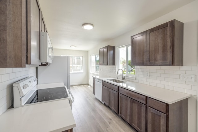 624 N Herald Rd Unit 2, Spokane Valley, WA 99206 - kitchen featuring white appliances, a sink, tasteful backsplash, light wood-style flooring, and light countertops
