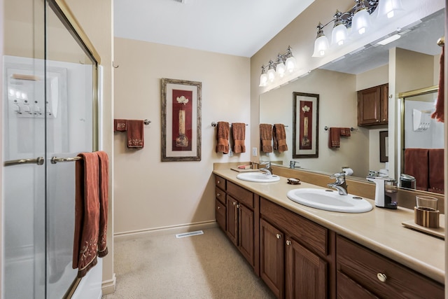 128C Buena Vista Rd, Colville, WA 99114 - bathroom with double vanity, an enclosed shower, and baseboards