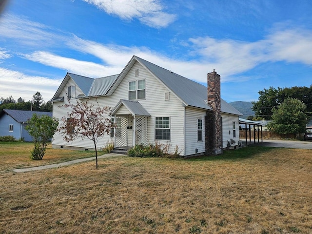 444 S Walnut St, Colville, WA 99114 - traditional-style home with crawl space, a chimney, a front lawn, and metal roof