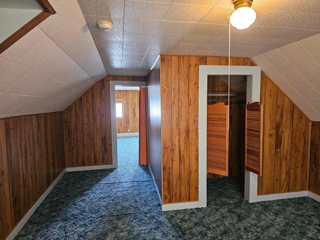 444 S Walnut St, Colville, WA 99114 - additional living space featuring wooden walls, carpet floors, vaulted ceiling, and baseboards