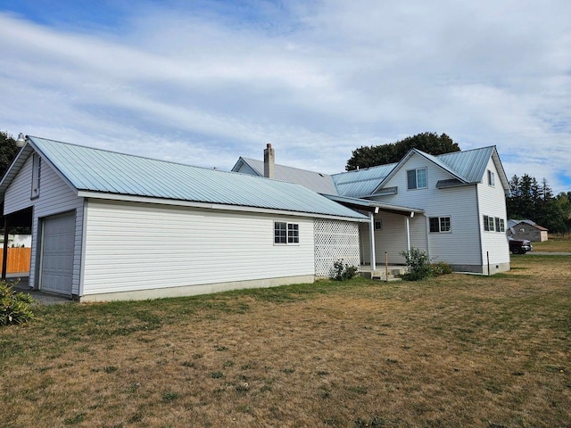 444 S Walnut St, Colville, WA 99114 - back of house featuring a yard, metal roof, and a chimney