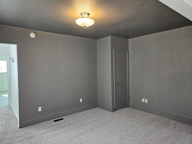 444 S Walnut St, Colville, WA 99114 - carpeted empty room with a smoke detector, baseboards, and a textured ceiling