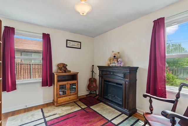 2503 W Upton Ave, Spokane, WA 99205 - sitting room with healthy amount of natural light, wood finished floors, a fireplace, and baseboards