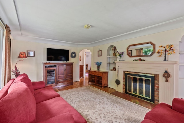 2503 W Upton Ave, Spokane, WA 99205 - living room featuring arched walkways, a brick fireplace, and wood finished floors