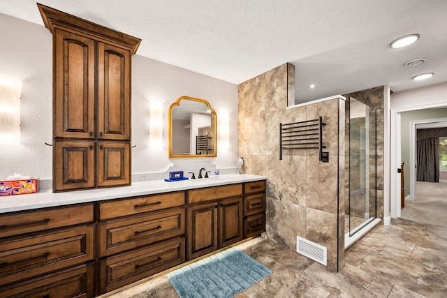 10101 N Pines Rd, Hayden, ID 83835 - full bathroom with a shower stall, vanity, and a towel warming rack