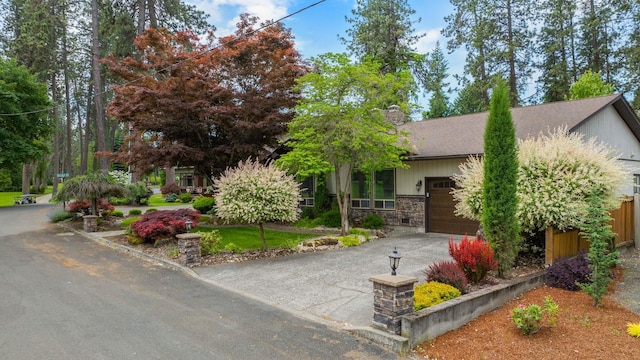 10101 N Pines Rd, Hayden, ID 83835 - view of property hidden behind natural elements with an attached garage, asphalt driveway, and roof with shingles
