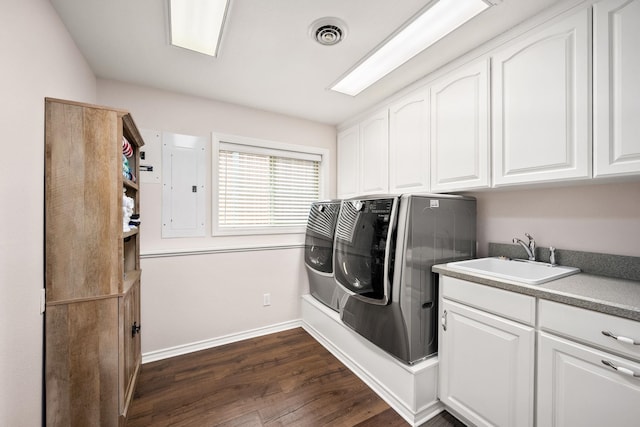 10101 N Pines Rd, Hayden, ID 83835 - laundry area featuring electric panel, dark wood finished floors, washer and dryer, cabinet space, and baseboards