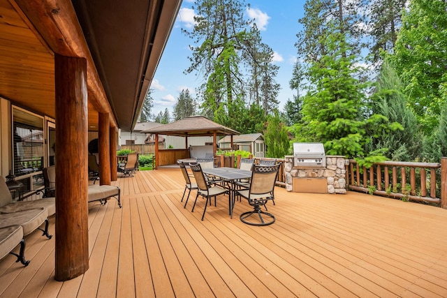 10101 N Pines Rd, Hayden, ID 83835 - wooden deck with outdoor dining space and a grill