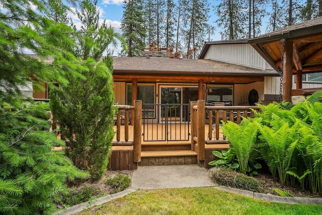 10101 N Pines Rd, Hayden, ID 83835 - view of exterior entry featuring a chimney and a shingled roof