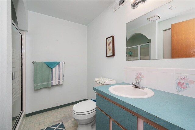 13715 E Rich Ave, Spokane Valley, WA 99216 - full bathroom with vanity, tile patterned floors, a stall shower, toilet, and tasteful backsplash