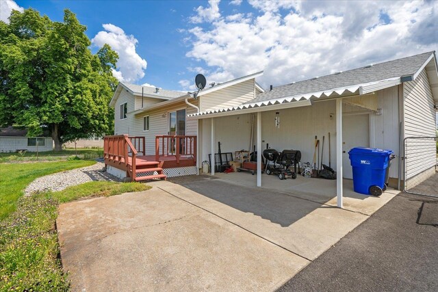 13715 E Rich Ave, Spokane Valley, WA 99216 - rear view of house with a wooden deck, a patio area, roof with shingles, and a garage