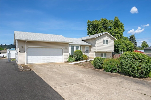 13715 E Rich Ave, Spokane Valley, WA 99216 - tri-level home with an attached garage, driveway, and a shingled roof
