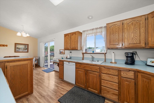 13715 E Rich Ave, Spokane Valley, WA 99216 - kitchen with dishwasher, a sink, vaulted ceiling, brown cabinetry, and light countertops