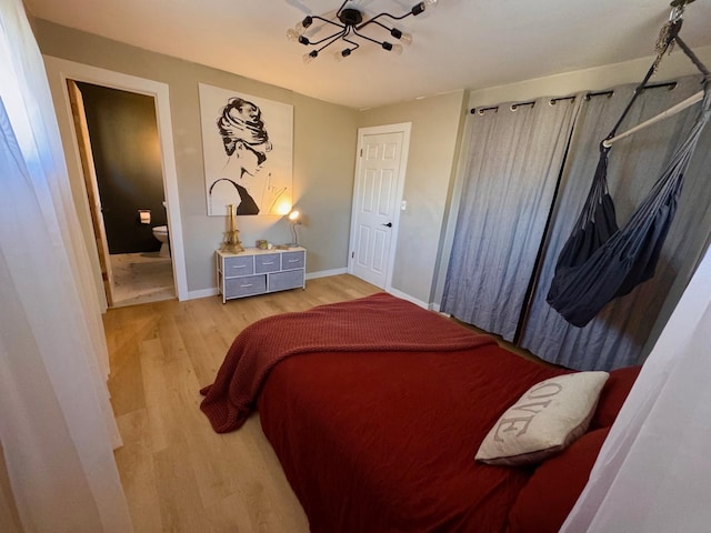 8616 E Desmet Ave, Spokane Valley, WA 99212 - bedroom with light wood-style floors, baseboards, a chandelier, and connected bathroom