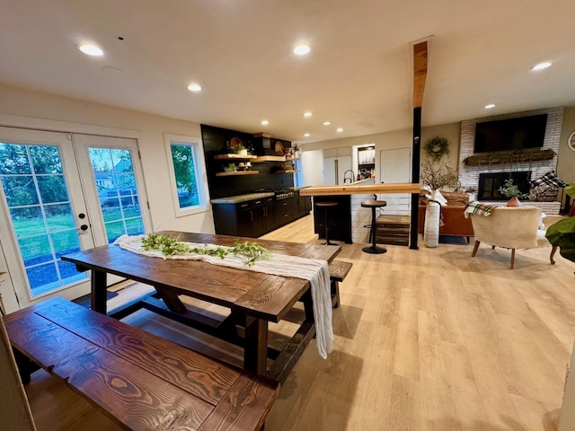 8616 E Desmet Ave, Spokane Valley, WA 99212 - dining room featuring french doors, a fireplace, light wood-style floors, and recessed lighting
