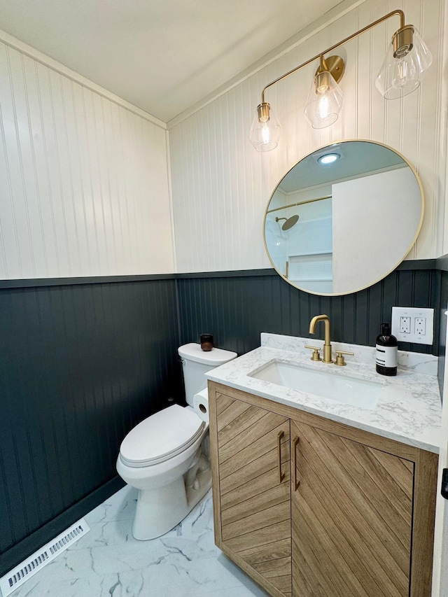 8616 E Desmet Ave, Spokane Valley, WA 99212 - half bath with vanity, marble finish floors, toilet, wood walls, and wainscoting