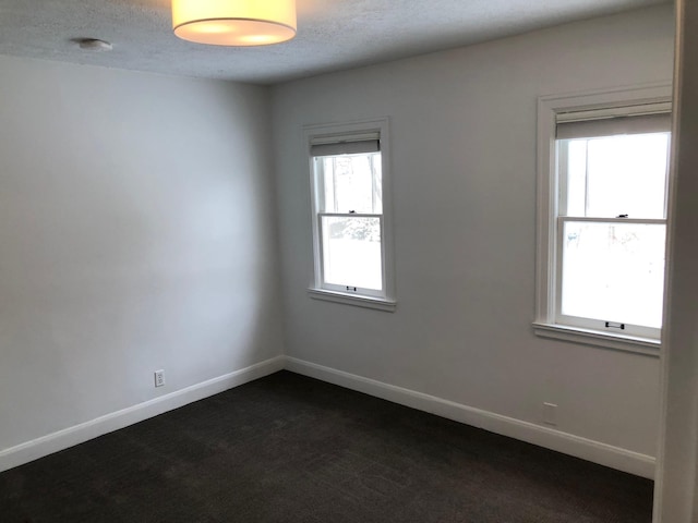 1617 S Bernard St, Spokane, WA 99203 - empty room with dark colored carpet, a textured ceiling, baseboards, and a smoke detector
