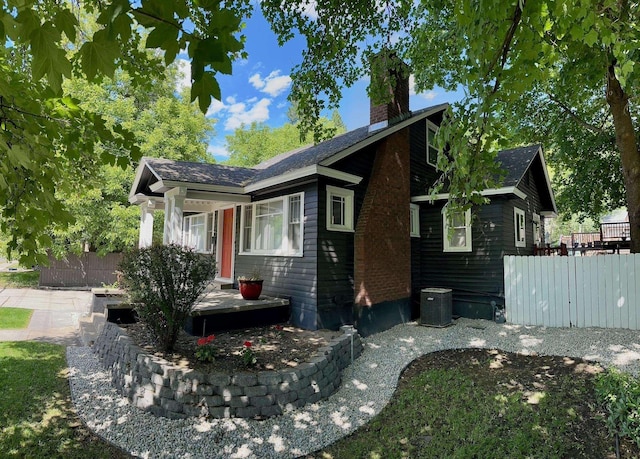 1617 S Bernard St, Spokane, WA 99203 - view of side of home featuring a chimney, cooling unit, and a wooden deck