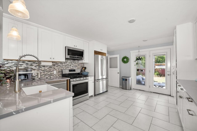 1306 W Euclid Ave, Spokane, WA 99205 - kitchen featuring stainless steel appliances, a sink, backsplash, and white cabinets