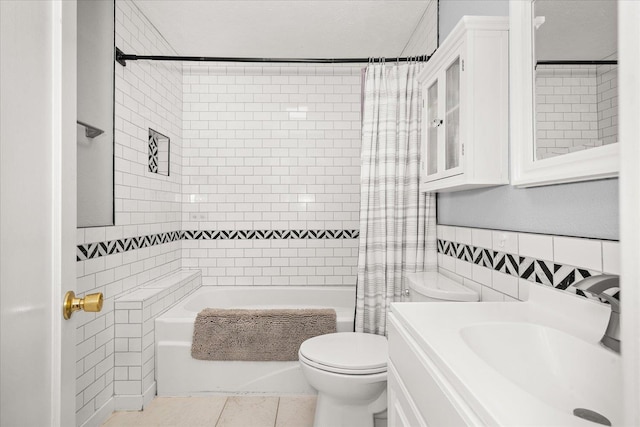1306 W Euclid Ave, Spokane, WA 99205 - bathroom with tile walls, toilet, shower / bath combo with shower curtain, vanity, and tile patterned floors