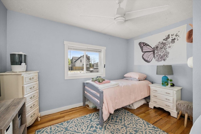 1306 W Euclid Ave, Spokane, WA 99205 - bedroom with wood finished floors, ceiling fan, and baseboards