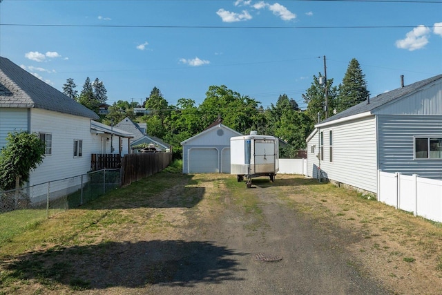 1306 W Euclid Ave, Spokane, WA 99205 - view of yard with driveway, a detached garage, and an outdoor structure