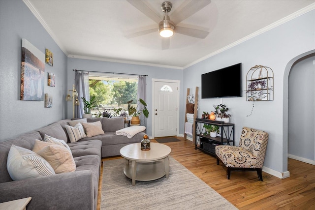 1306 W Euclid Ave, Spokane, WA 99205 - living room featuring arched walkways, wood finished floors, crown molding, ceiling fan, and baseboards