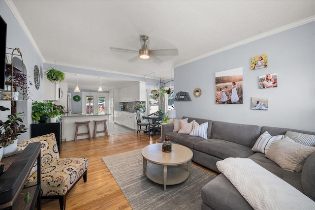 1306 W Euclid Ave, Spokane, WA 99205 - living room featuring light wood finished floors, a ceiling fan, and ornamental molding