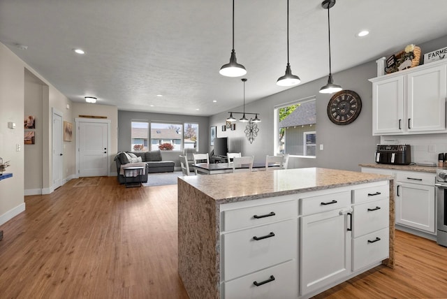 1812 E Columbia Ave, Spokane, WA 99208 - kitchen with healthy amount of natural light, a kitchen island, light wood-style floors, and recessed lighting