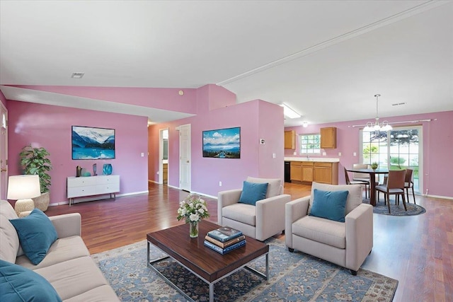 12512 W 10th Ave, Airway Heights, WA 99001 - living area with lofted ceiling, wood finished floors, a chandelier, and baseboards