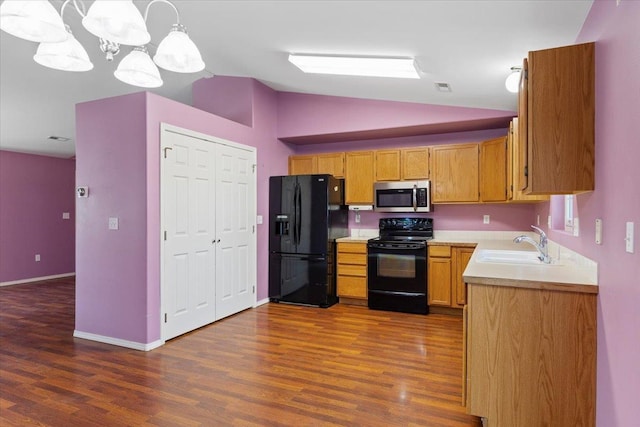 12512 W 10th Ave, Airway Heights, WA 99001 - kitchen with black appliances, a sink, lofted ceiling, dark wood-type flooring, and light countertops