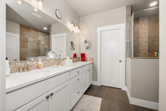 1473 W Jay Ct, Spokane, WA 99208 - bathroom with tiled shower, double vanity, tile patterned floors, and baseboards