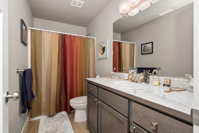 1473 W Jay Ct, Spokane, WA 99208 - full bath featuring vanity, wood finished floors, toilet, and a shower with shower curtain