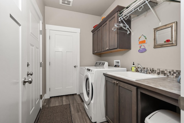 1473 W Jay Ct, Spokane, WA 99208 - laundry area featuring cabinet space, washer and clothes dryer, and dark wood finished floors